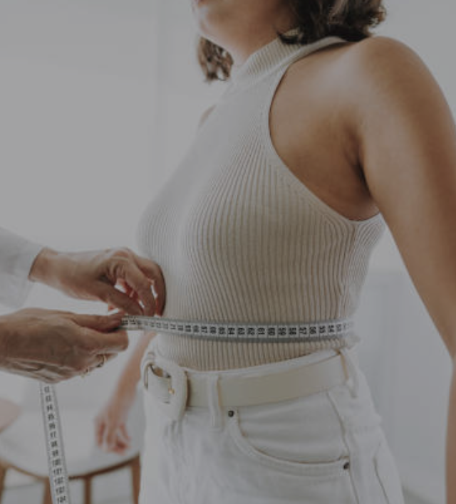 Woman measuring waist showing GLP-1 weight loss results